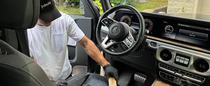 a detailer cleaning the steering wheel