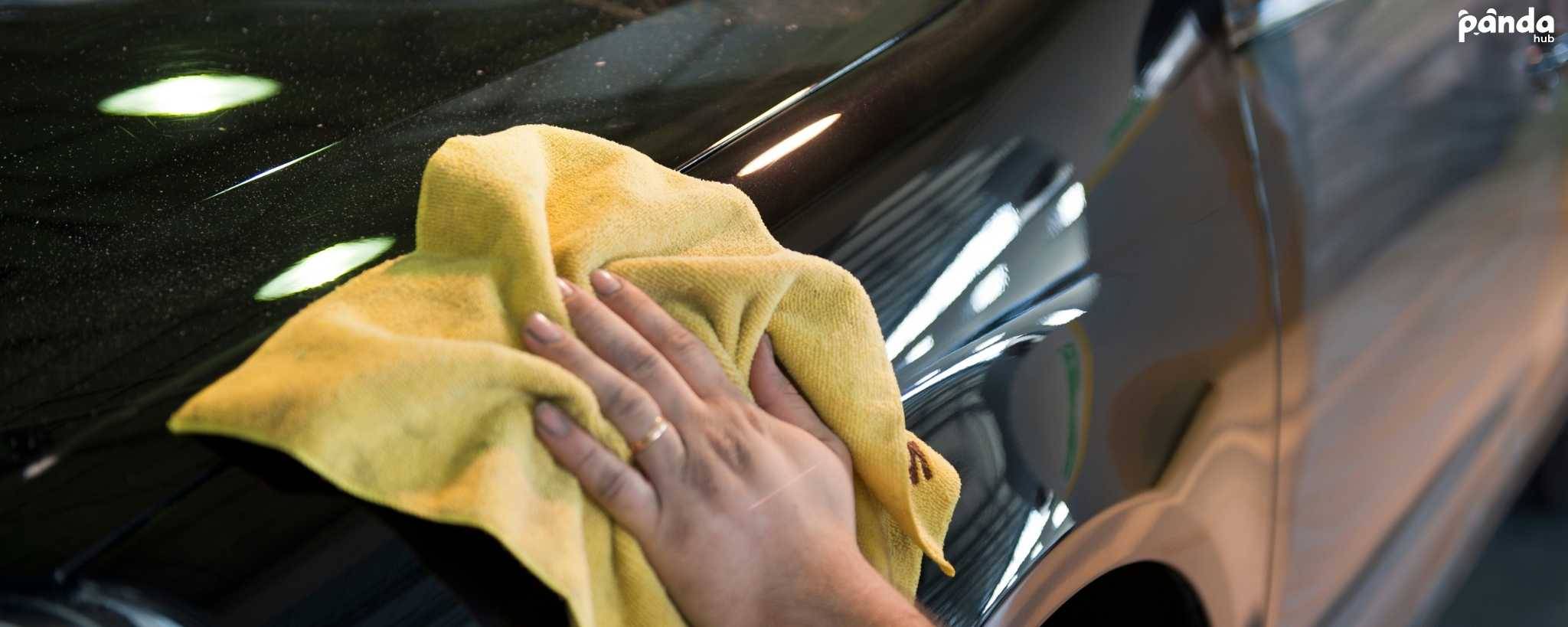 Drying the car exterior with a microfiber towel